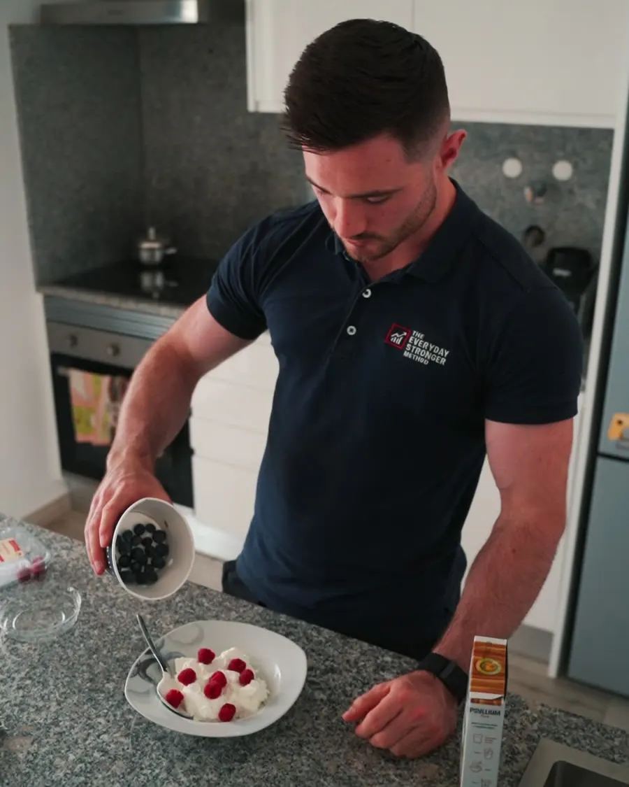 Eoin preparing a simple breakfast of yoghurt and berries at home